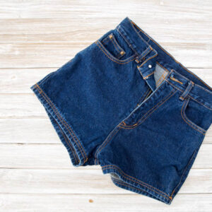 Old short denim on rustic white wooden table