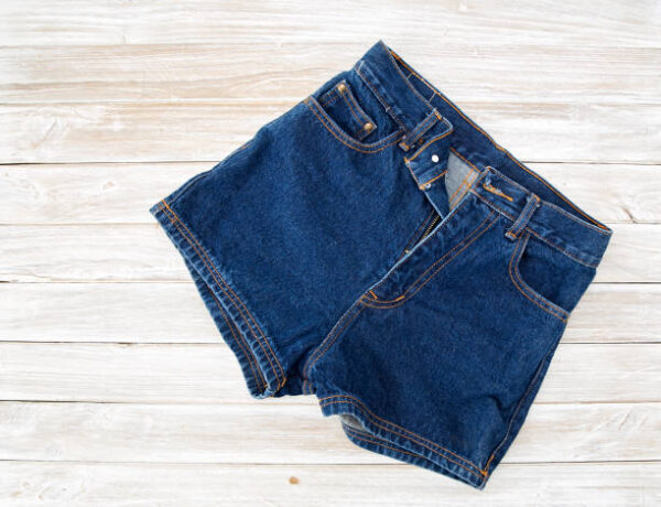 Old short denim on rustic white wooden table